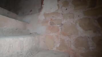 A stairway in an old building with a wall video