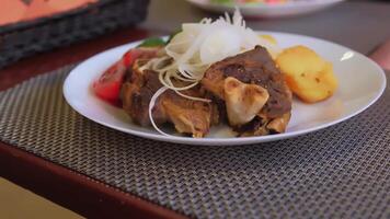A plate with meat and vegetables on it video