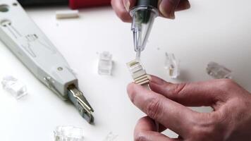 Hand Testing and Assembling Ethernet Connector with Network Cable in a Clean Workspace Environment video