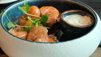 Delicious fresh shrimps served with creamy dipping sauce and garnished with herbs in elegant bowl video