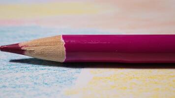 Close up of colored pencil lying on paper in creative office workspace video
