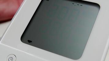 Close-Up of Digital Blood Pressure Monitor Display Showing Systolic Reading in Medical Setting video