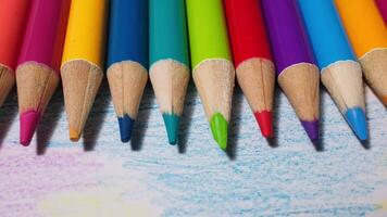 Vibrant Colored Pencils Lined Up on Colored Paper in a Creative Office Setting video