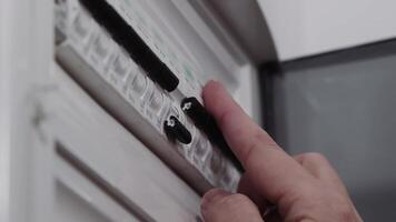 de cerca de un persona ajustando un cambiar en un eléctrico circuito interruptor automático panel, enfoque en hogar seguridad, mantenimiento, y eléctrico trabajar. video