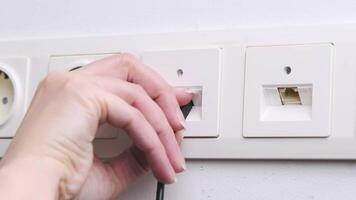 Close-up of Hand Plugging Ethernet Cable into Wall Socket in Modern Indoor Office Environment video