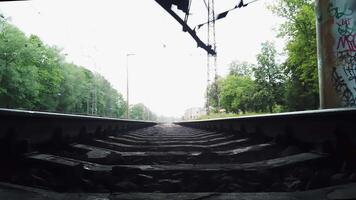 A view of the railroad tracks from inside a train video