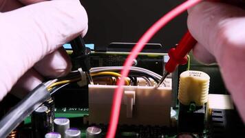 Close-up of Technician Testing Electronic Circuit Board with Multimeter Probes in Laboratory Environment video