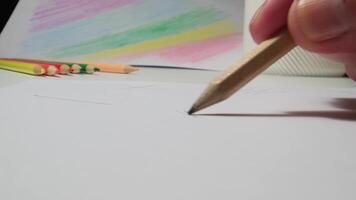 Close-Up of Hand Drawing with Pencil on Paper in Creative Workspace Environment video