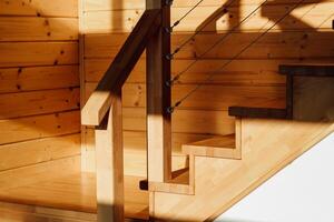 Elegant wooden staircase design with sunlight illuminating natural textures and shapes photo