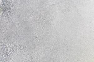 Textured surface of frost covering an outdoor landscape during winter photo
