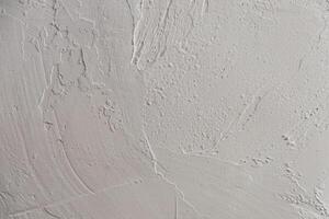 Abstract textured wall surface with subtle variations in white tones and patterns photo