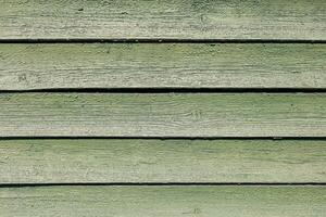 Weathered green wooden planks arranged in a horizontal pattern with natural texture and lines photo