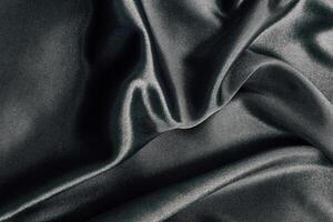 Elegant dark fabric draped softly on a smooth surface for textile design and inspiration photo