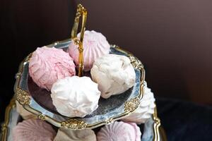 Delicious meringue cookies arranged on an elegant serving tray in soft colors photo