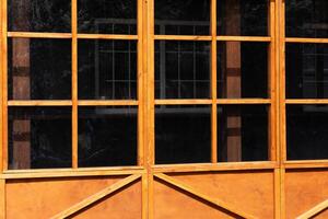 Wooden window structure with multiple panes in a building during bright daytime photo