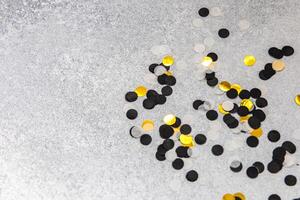 Colorful confetti scattered on a silver surface for celebration events and parties photo