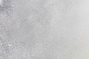 Textured surface of light gray concrete with subtle variations in tone and detail photo