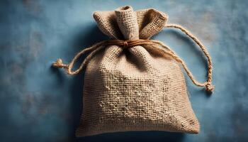One burlap sack on blue background, top view. Space for text photo
