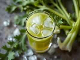 Refreshing Celery Juice with Ice Cubes and Fresh Celery photo