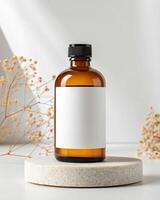 Blank white label mockup of a bottle of essential oil on a white background photo