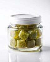 A jar filled with green gummy bears photo