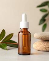 Essential oil bottle with leaves and stones on a white background photo