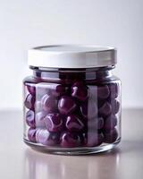 A jar filled with purple grapes photo