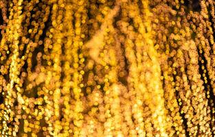 Gold Bokeh Lights Abstract Background. bokeh background with bright lights on night background photo