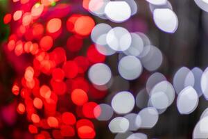 Abstract colorful bokeh orbs on dark background, vibrant defocused light dots pattern photo