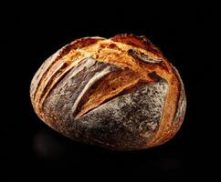 Artisanal crusty bread loaf on dark surface for culinary use photo