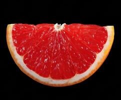 Fresh red grapefruit slice on a dark background for culinary design photo