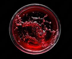 Vibrant liquid splash in a glass bowl on a dark background photo