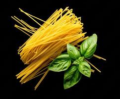 Fresh basil and spaghetti for Italian cuisine preparation photo