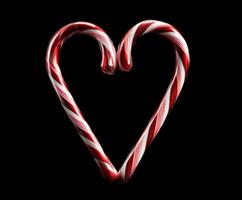 Heart shape created with candy canes for festive decoration photo