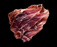 Delicious cured meat slice on dark background for gourmet dishes photo