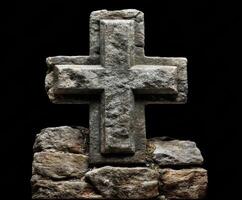 Medieval stone cross on rocky base in dark setting photo