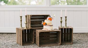 Rustic Wedding Cake Display with Wooden Crates and Candles photo