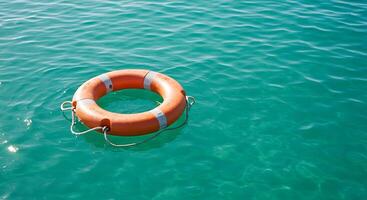 An orange life preserver floating in the water photo