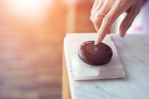 Hand pressing the call button on table photo