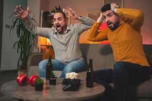 Friends share an intense moment as they react to a surprising plot twist while enjoying a gaming night at home photo