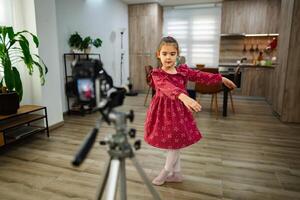 Little dancer performs gracefully in a cozy home space while being filmed for a fun project photo
