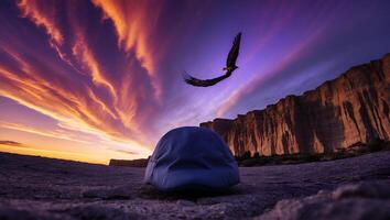 Hat with Eagle Flying Over Rock Formation at Sunset photo