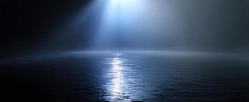 The enchanting beauty of light breaking through the ocean's misty surface. photo