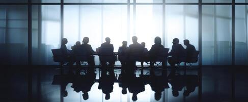 The silhouettes of professionals engaged in a high-stakes business meeting. photo