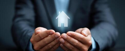 The Hands Holding a Digital Representation of a House for Homeownership Concept photo