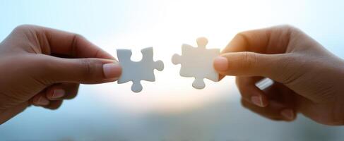 The Hands Connecting Two White Puzzle Pieces in Symbolic Unity photo