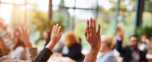 The hands raised during an engaging group discussion in a bright meeting space photo