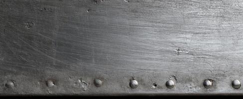 The metallic texture with rivets showcasing industrial elegance in design. photo