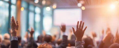 The engaged audience with raised hands during an interactive conference session. photo