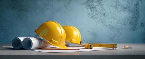 The construction helmets and blueprints on a workbench for engineering projects. photo